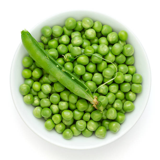 istock Fresh garden peas in a ceramic dish shot from above 512473875
