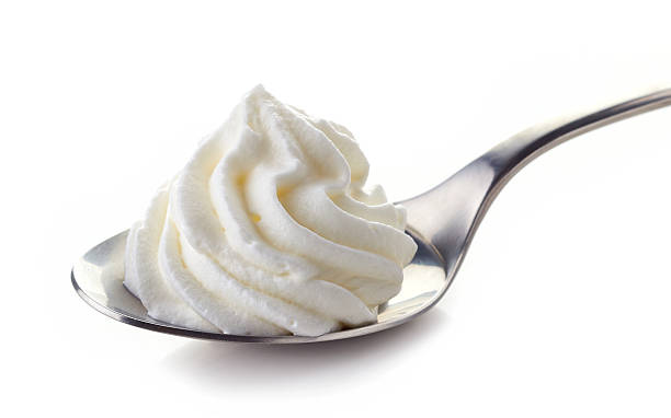 istock spoon of whipped cream 512474404