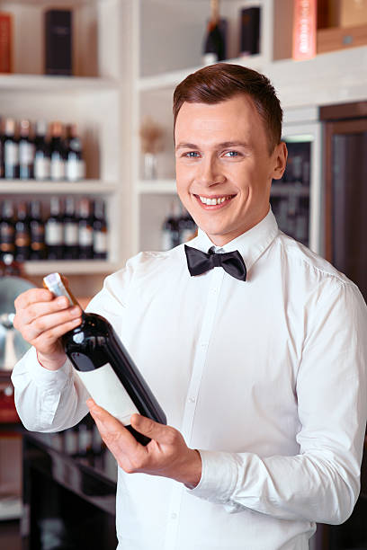 istock Professional sommelier holding wine bottle 512474860