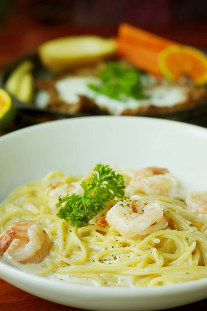 istock spaghetti with shrimp and white cream sauce. 512475231