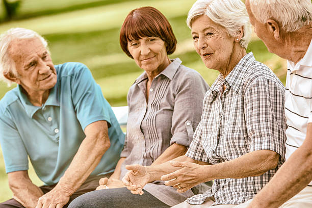 istock Seniors sitting on park bench 512475386