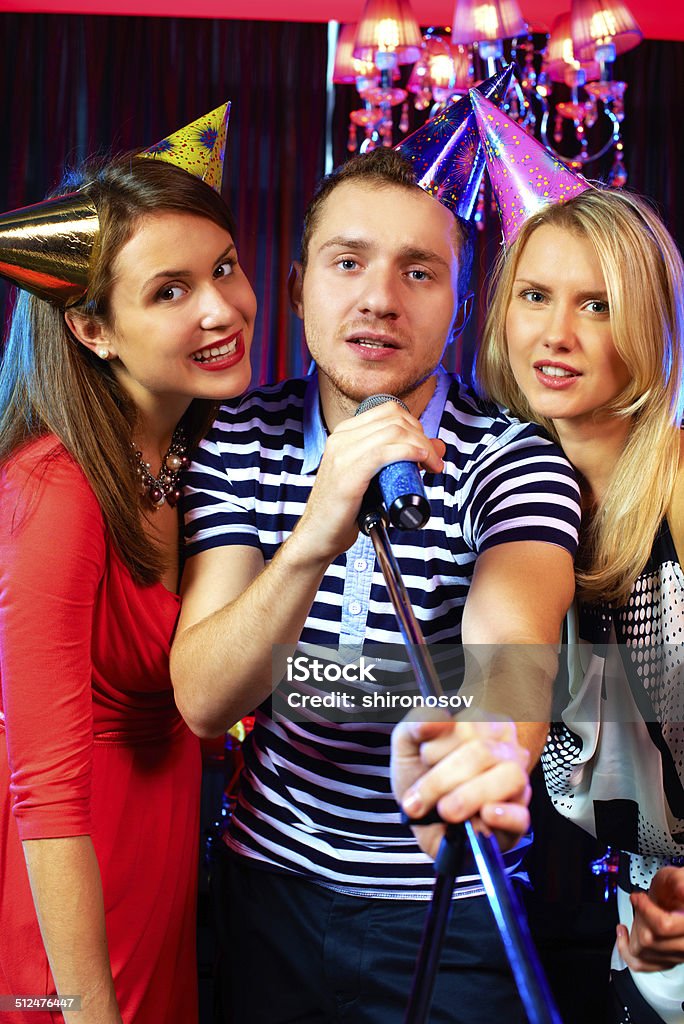 Entertainment Portrait of happy people singing in the karaoke bar Adult Stock Photo