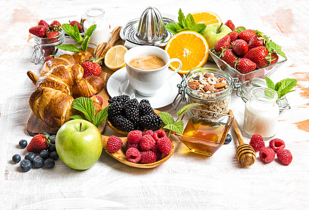 istock Breakfast with coffee, croissants, muesli, berries, fruits 512477024
