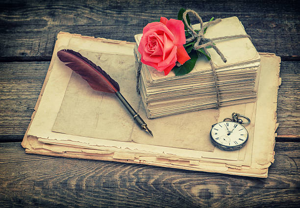 istock Old postcards and letters with red rose flower 512477146