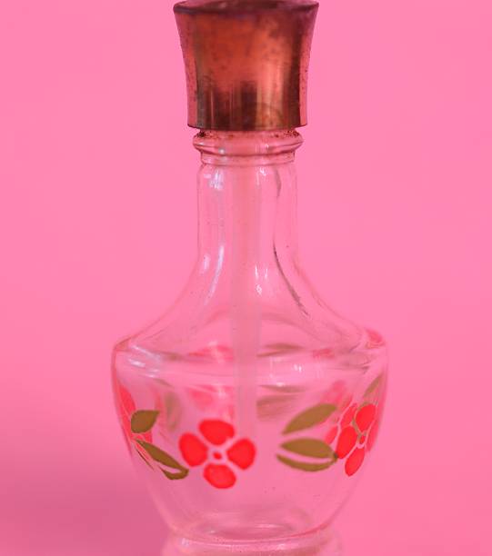 istock Old parfum bottle with red flowers, vintage 512477224