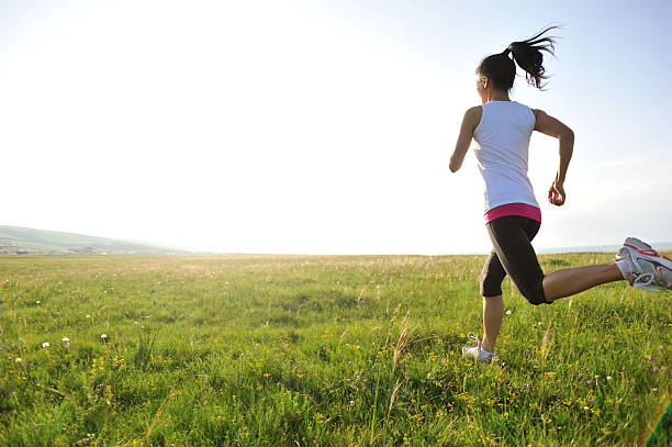 istock Runner athlete running on sunrise/sunset grass field 512478739