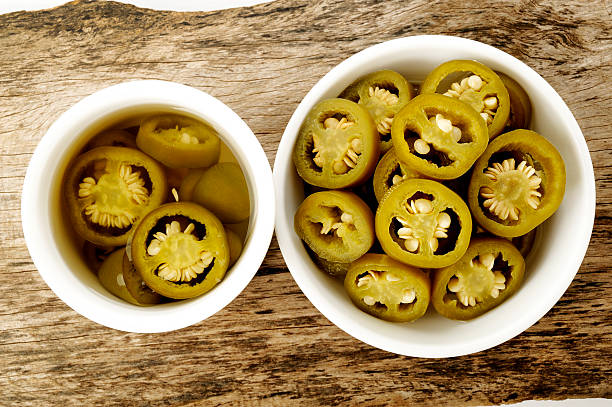 istock pickled sliced green jalapeno peppers in white bowl 512478811