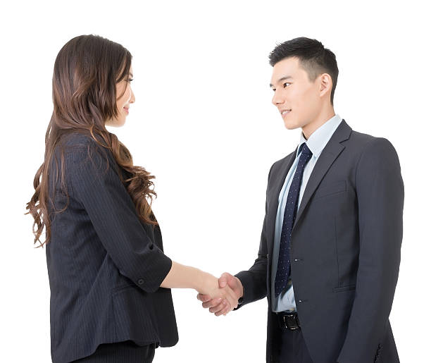 Business woman and man shake hands stock photo