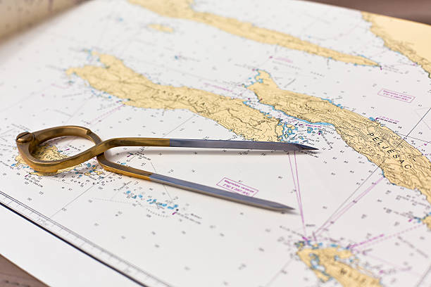 istock Pair of compasses for navigation on a sea map 512479419