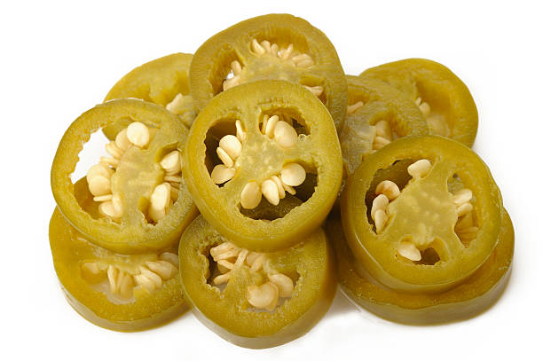istock pickled sliced green jalapeno peppers on white background 512480217