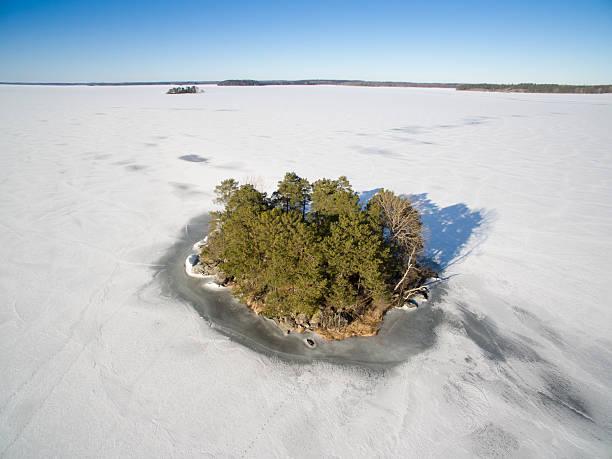 istock Island on a frozen lake 512488852