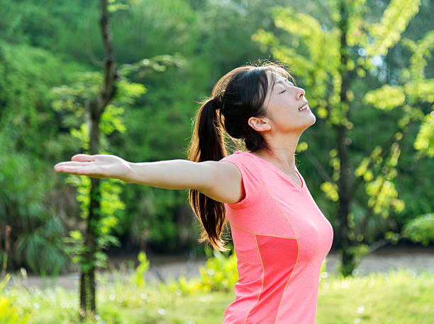 istock Asian woman enjoying fresh air 512489350