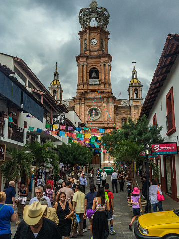 Puerto Vallarta, Mexico - January 3, 2015: Tourists on a major street in the old part of central Puerto Vallarta. Photo taken during the day, and contains some vehicular and pedestrian activity.