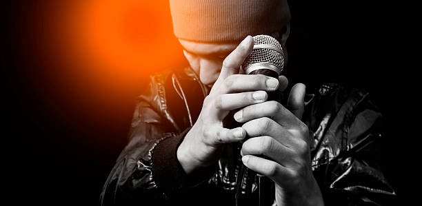 asian handsome singer posing on dynamic microphone stock photo
