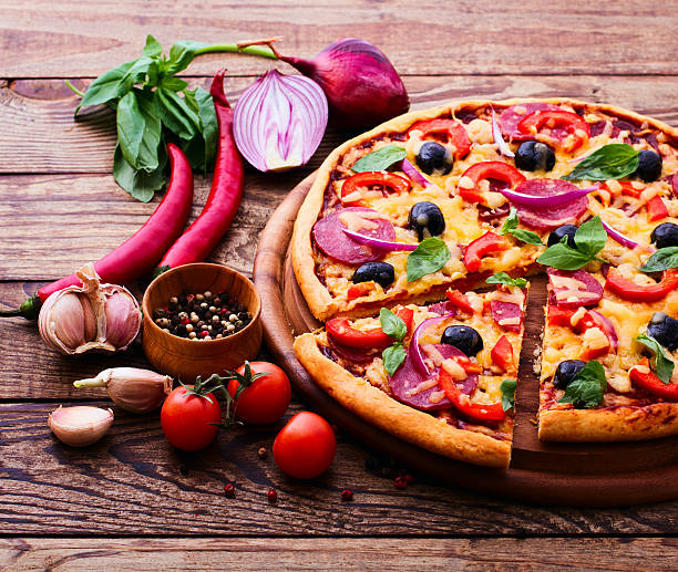 istock Pizza with ham, pepper and olives. 512490925