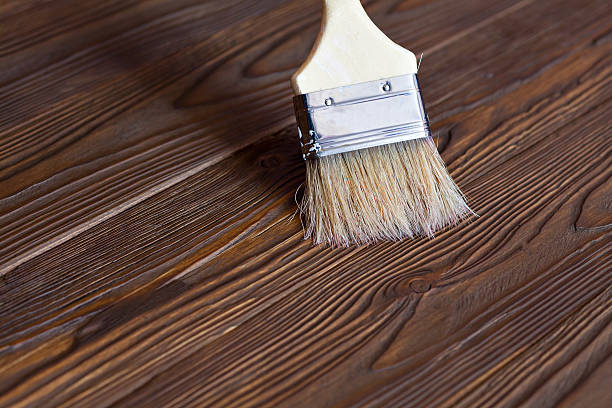 istock Painting natural wood with paint brush 512491890