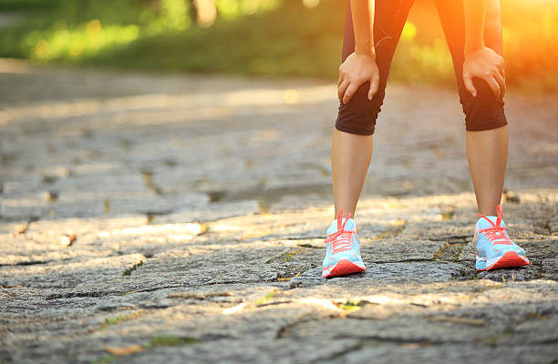 istock tired woman runner  have a rest after running hard 512491911