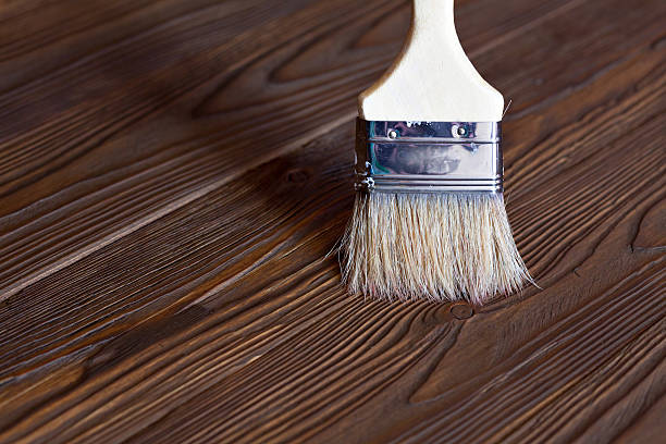 istock Painting natural wood with paint brush 512491914