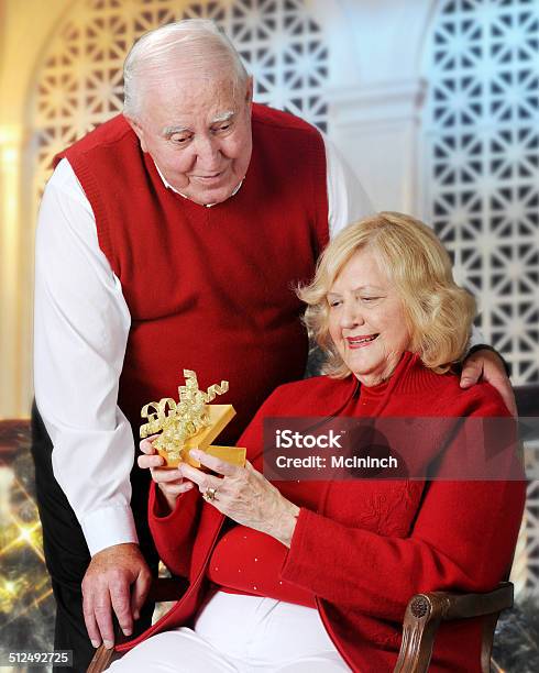 Senior Woman Opening Christmas Gift Stock Photo - Download Image Now - Active Seniors, Adult, Blond Hair