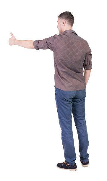 istock Back view of  man in checkered shirt shows thumbs up. 512492921