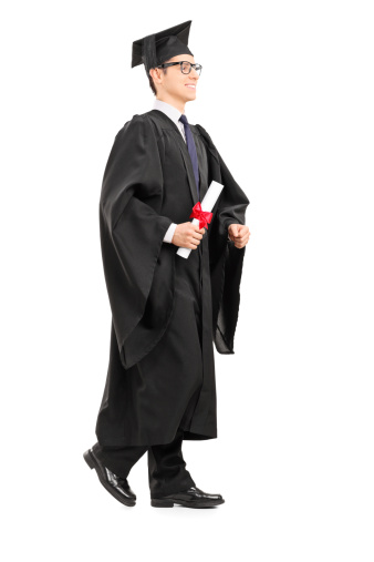 Graduate student walking with diploma in his hand isolated on white background