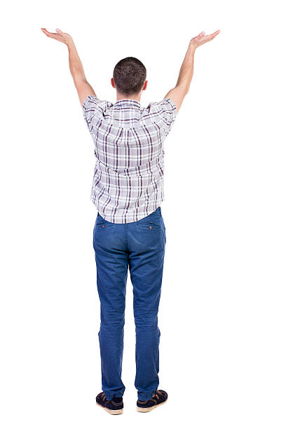 istock Back view of Beautiful man in jeans looking at wall 512493393