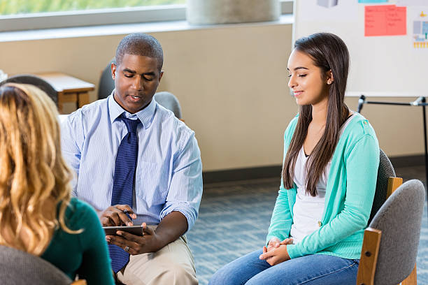 istock School counselor talks with high school students about bullying 512494086