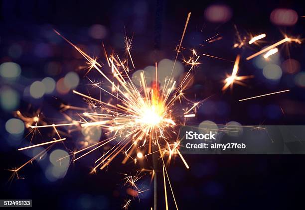 Holiday Background With A Sparkler Stock Photo - Download Image Now - Sparkler - Firework, Burning, Bright