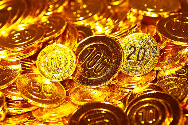 istock Golden coins piled in a heap of background 512495594