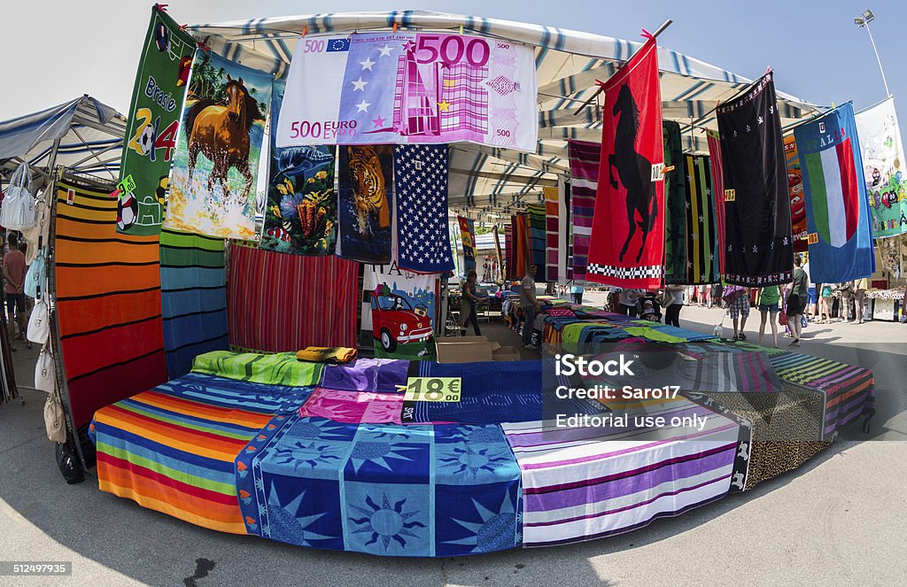 Caorle beach towels for sale ! Caorle, Italy - June 07, 2014 - Lots of colored beach towels are waiting for customers at a street market stall. Awning Stock Photo