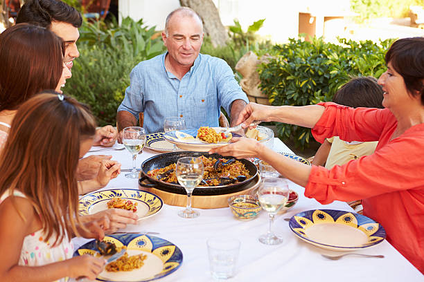istock Multi Generation Family Enjoying Meal On Terrace Together 512498203