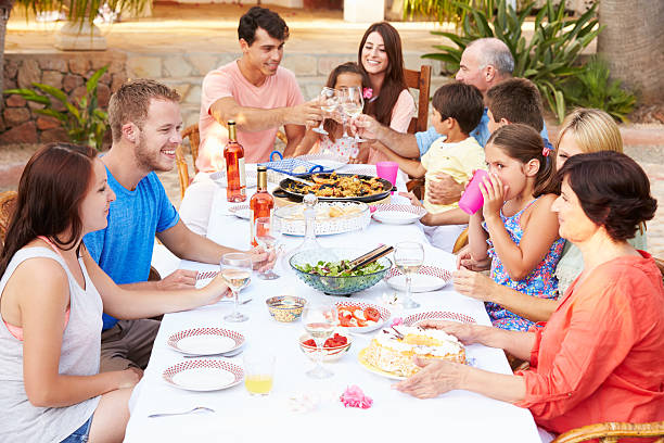 istock Large Family Group Enjoying Meal On Terrace Together 512498295
