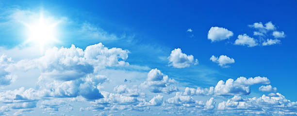 istock White heap clouds and bright sun in the blue sky. 512507886