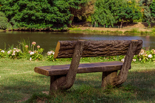 Empty bench on the lake in summer day
