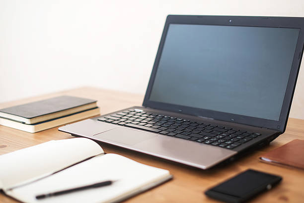 istock Office workplace with laptop, smart phone and notebook on table 512510454