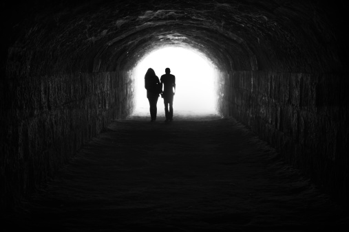 Couple and light in the end of the tunnel. Hope and freedom