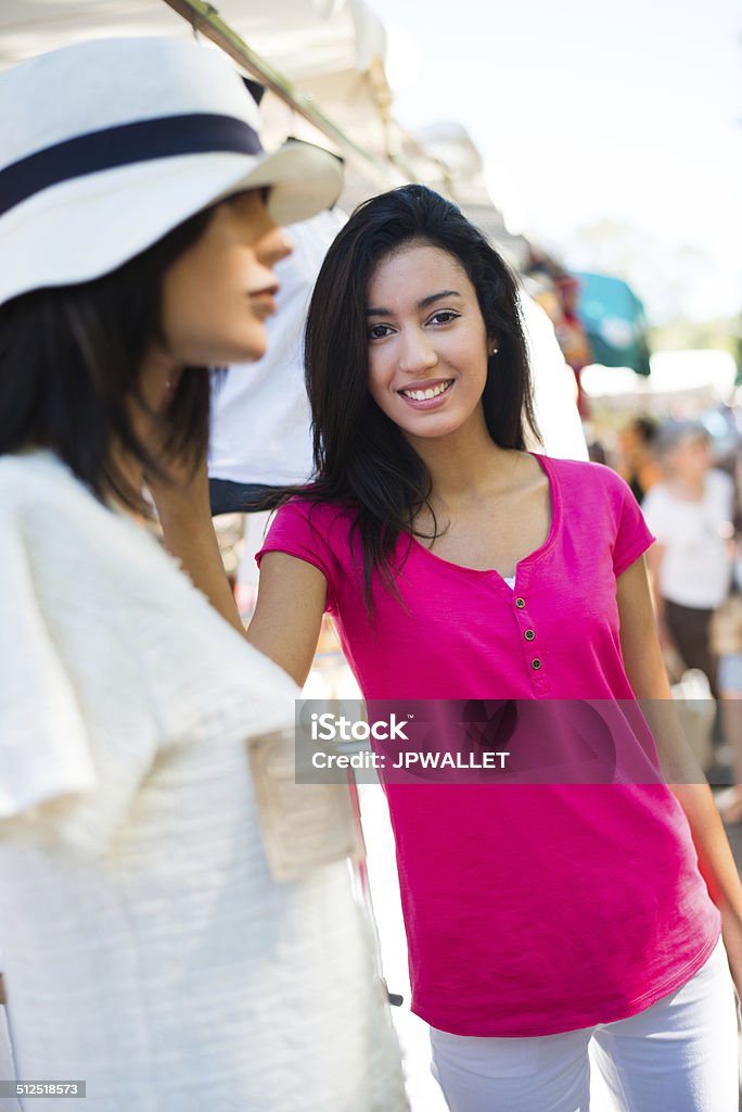 cheerful healthy young woman shopping in farmers market buying clothes cheerful healthy young woman shopping in farmers market and buying clothes Adult Stock Photo