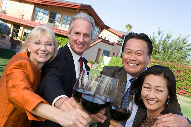 Friends toasting with wine in garden