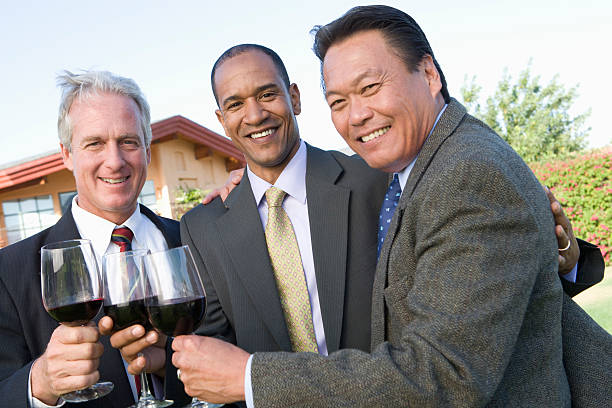 istock Friends toasting with wine in garden 512519497
