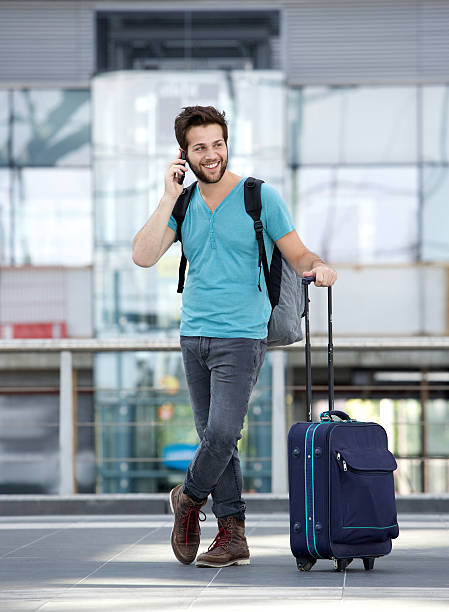 istock Male traveler talking on mobile phone 512519783
