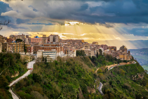 sun breaking through the clouds above the highest city in Sicily - Enna