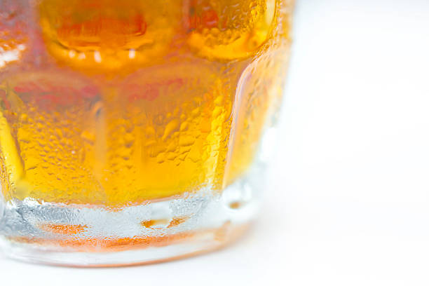 Cold and fresh beer on a glass jar. Close up shot isolated on a white background.