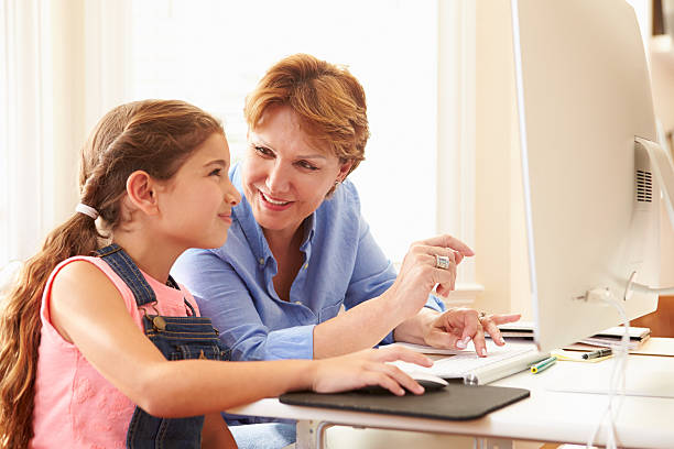 istock Grandmother And Granddaughter Using Computer At Home 512521881