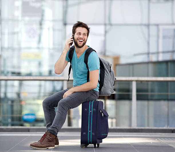 istock Young man calling by mobile phone at airport 512522051