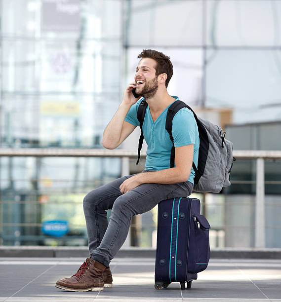 istock Man relaxing at airport and talking on mobile phone 512522053