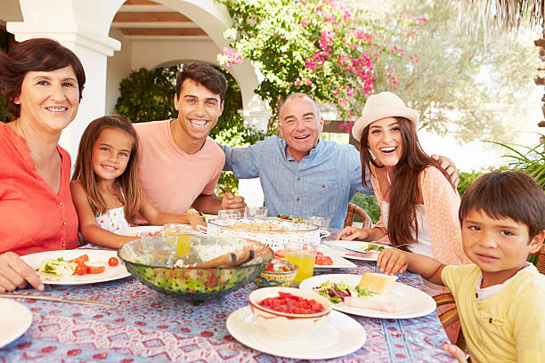 istock Multi Generation Family Enjoying Meal On Terrace Together 512522067
