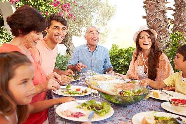 istock Multi Generation Family Enjoying Meal On Terrace Together 512522117
