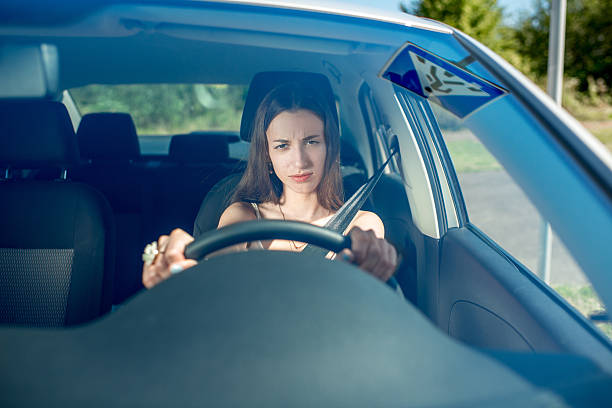istock Young woman driving car. Windshield view 512522275