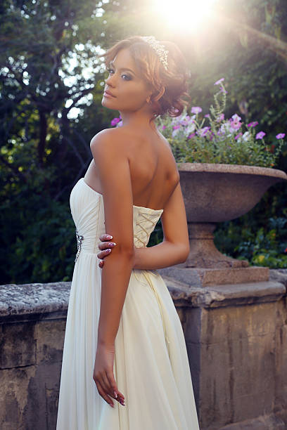 istock beautiful bride in elegant dress posing in sunlight rays 512522355