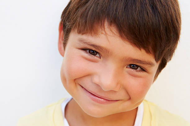 istock Portrait Of Young Hispanic Boy Standing By Wall 512522393